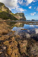 Fototapeta na wymiar Reflections at Salmon Beach looking towards Mount Lidgbird and Mount Gower, Lord Howe Island, Australia