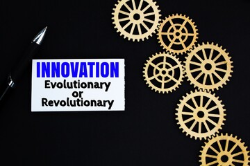 gear teeth and white paper with the words Innovation Evolutionary or Revolutionary. 