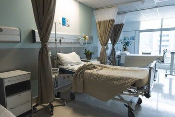 General view of patient room with beds and medical equipment at hospital