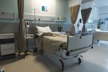 General view of patient room with beds and medical equipment at hospital
