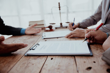 Close-up view. Company executives sign business contracts with business partners and legal advisors...