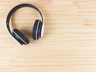 flat lay of headphones on wooden table background, copy space.