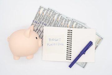 Money budget planning. Piggy bank with notebooks on white background, financial goal concept.