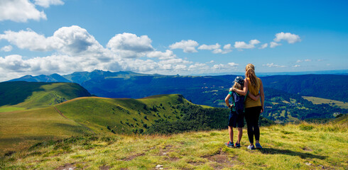 Mother and son enjoying mountain panoramic view- Massif central, Auvergne in France- family sport, travel, tourism, adventure concept
