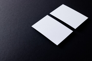 White business cards with copy space on black background