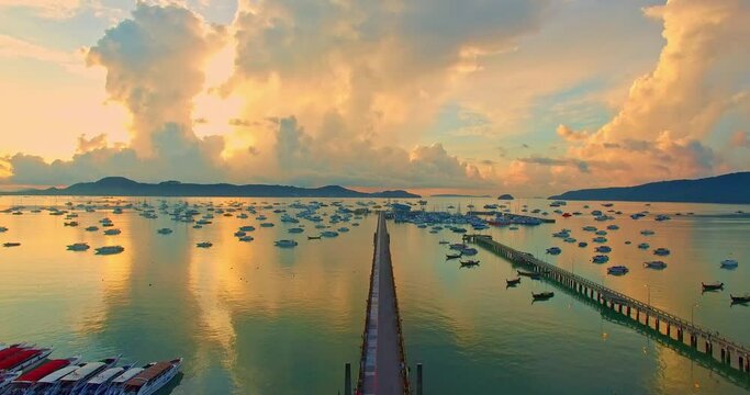 beautiful sunrise cloud above Chalong pier..Sunrise with sweet yellow color light rays and other atmospheric effects..colorful reflection of sunrise in the sea background..gradient color sky texture.