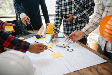 Engineer teams meeting working together wear worker helmets hardhat on construction site in modern city.
