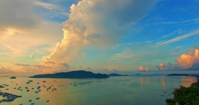 beautiful sunrise cloud above Chalong pier..Sunrise with sweet yellow color light rays and other atmospheric effects..colorful reflection of sunrise in the sea background..gradient color sky texture.