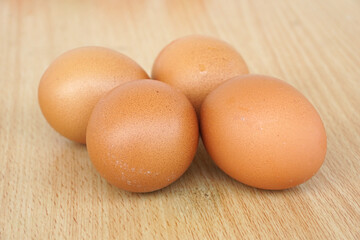 Raw chicken eggs on wooden 
 background    