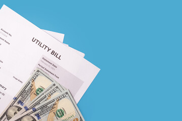 Price details on utility bill, Paper bill with energy and water charges, blue background, copy space