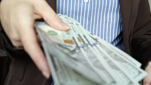 give a bribe, financial crimes, corruption, bribe for a political favor, illegal business, woman official counts cash money dollars