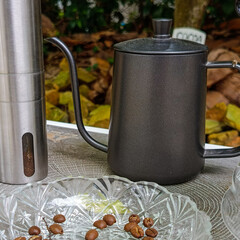 coffee pot and glass with coffee bean rock nature background