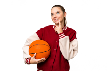 Young blonde woman playing basketball over isolated chroma key background thinking an idea while looking up
