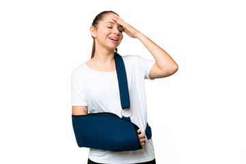 Young blonde woman with broken arm and wearing a sling over isolated chroma key background smiling a lot
