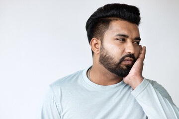 Young South Asian Man suffering from Toothache, Tooth decay, Tooth pain, gingivitis, Seeking Dental...