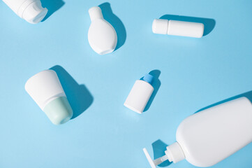 Still life with mockup tester bottles for brand packaging and design, with beauty cosmetic products on blue background
