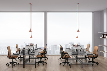 White office interior with armchairs and desk with laptop, panoramic window
