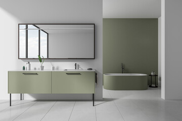 Fototapeta na wymiar Modern hotel bathroom interior with double sink and bathtub, accessories