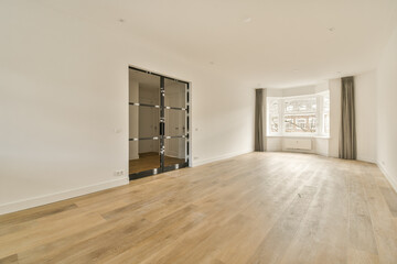 an empty living room with wood flooring and white walls in the room is very clean, but there is no...