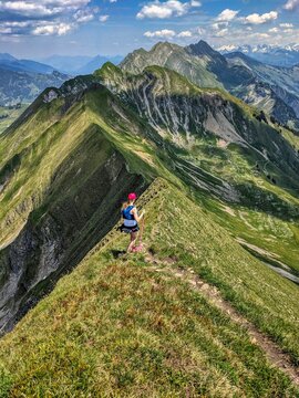 Trail running on the Hardergrat. Hiking on the harder ridge. Breathtaking view above Lake Brienz. Brienzer Rothorn. High quality photo