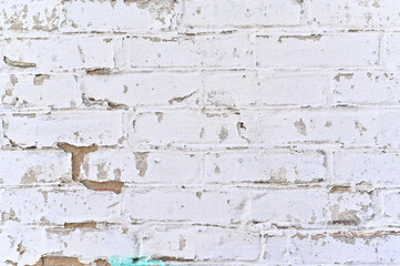 white wall background. Old grungy brick wall of horizontal texture. Brick wall background. Stone wallpaper. Grunge wall. Brick wall with white uneven plasters