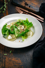 Summer green salad with pears, nuts and cottage cheese. Diet dish for vegans