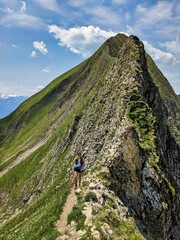 Woman runs over the Hardergrat above Lake Brienz. Mountain mountain ridge extreme trail running in switzerland. High quality photo