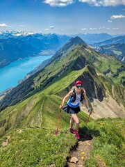 Trail running on the Hardergrat. Hiking on the harder ridge. Breathtaking view above Lake Brienz. Brienzer Rothorn. High quality photo