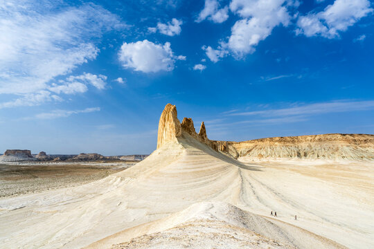 Ustyurt Plateau of Mangystau, Kazakhstan. Incredible desert scenery of a prehistoric seabed. Few people walking in the foreground