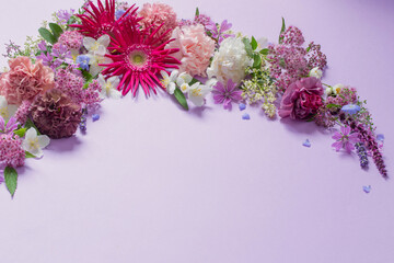 beautiful summer flowers on light purple background