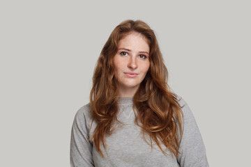 Redhead female model on white background, studio portrait