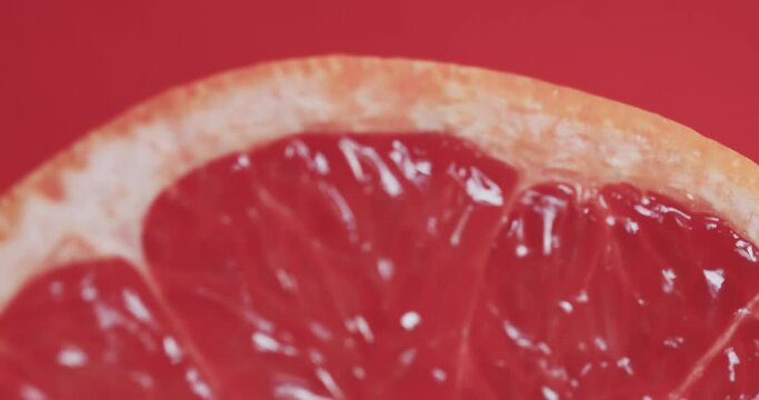 Video of sliced red grapefruit with copy space over red background