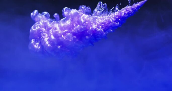 Video of close up of purple ink in water with copy space