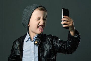 Child in Hat and Leather jacket doing selfie