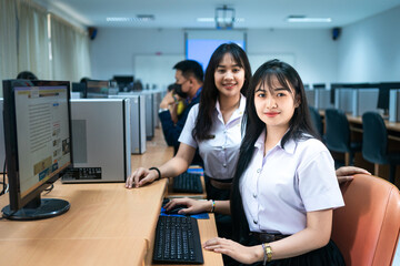 Asian college students attending computer class