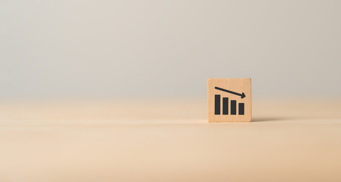 Lean manufacturing management. Cost reduction concept. Decreasing company expense cost to maximize profits. Wooden cube block with graph down icon .Business survival and improvement.