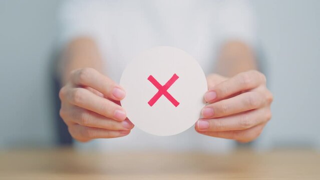 Woman show Wrong symbol paper. True and false, accept and rejected, evaluation, Vote, Poll, Yes or No and Survey concepts