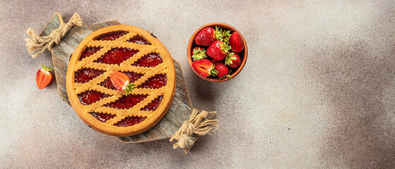 Tasty homemade raw strawberry pie with jam on a wooden board, Long banner format. top view