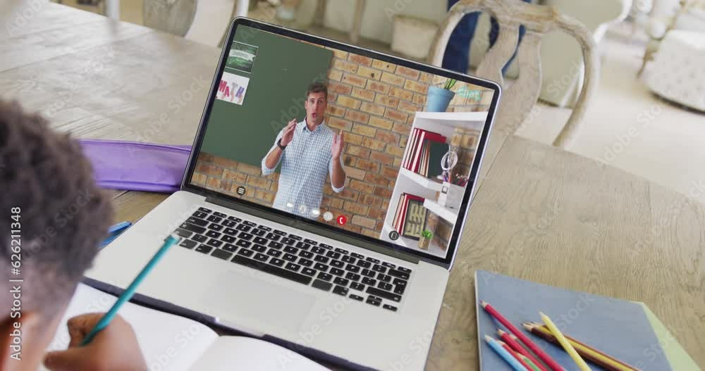 Canvas Prints Diverse male student having class during laptop video call with male teacher in slow motion