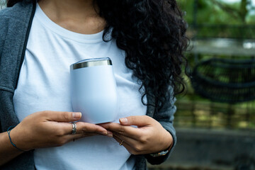Expertly crafted mockup: woman showcasing a white wine tumbler, perfect for promoting your exquisite drinkware collection