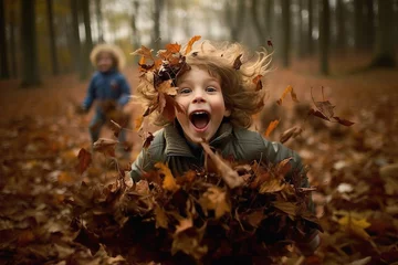 Foto op Canvas Children having fun with piles of autumn leaves © Juha Saastamoinen