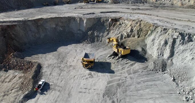 aerial view shot open pit mine coal mining, dumpers, quarrying extractive industry stripping work