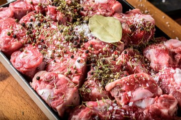 Savory Delicacy: Close-Up of Raw Oxtail Pieces Seasoned with Sea Salt and Spices, Showcasing Culinary Excellence in 4K Resolution