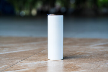 The mockup features a white tumbler, elegantly arranged with a simple style, enhancing its overall appeal