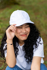 A captivating mockup displays a woman in a white hat, striking a simple pose, perfect for...