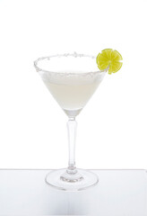 Margarita cocktail in a glass on a mirror counter bar isolated on white background, lemon slices and salt on the rim.