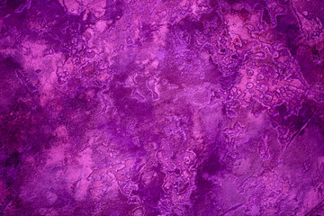 Background from decorative plaster with abstract patterns and stains. Fancy red and pink decoration wall texture, creative purple surface background. Finishing coating for building cladding.