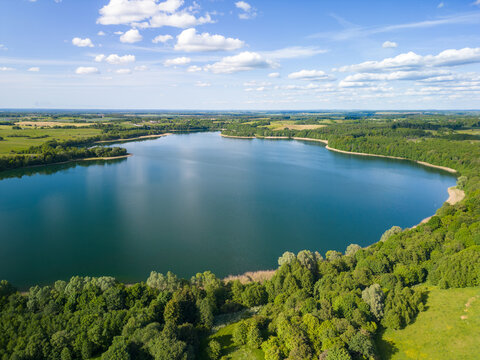 Aerial view of Lake Wuksniki - the deepest lake of the Masurian Lake District, Poland. Landscape of the Warmia region all around