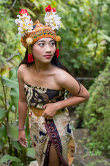 Fototapeta premium Nice Bali female in traditional costume at Bali island, Indonesia. Bali is one of the most popular tourist destinations in Indonesia.