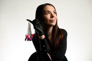 Fototapeta premium Elegant darkhair woman nails master wearing black uniform showing palette with nail polish colors samples
